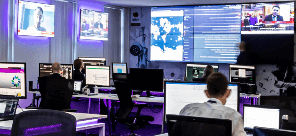 Mitie Intelligence Hub with employees sitting at desks with computers and big screens