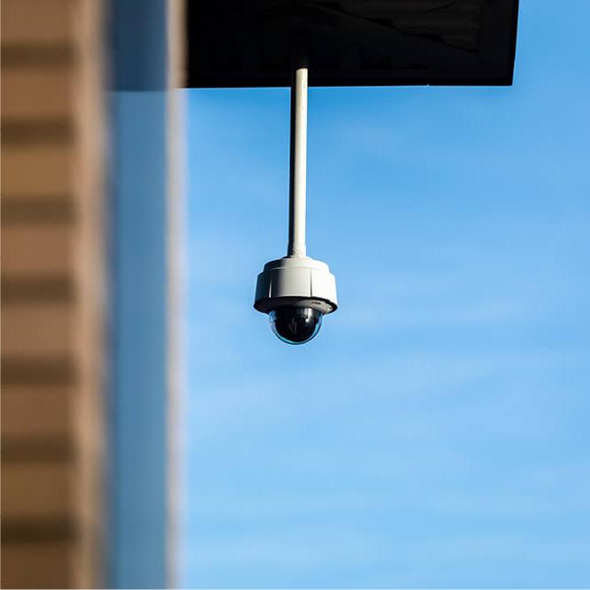 Security camera against a blue sky